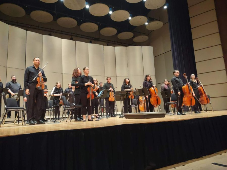 Members of the Washburn Symphony Orchestra stand to accept the final applause. The concert ended with the orchestra’s performance of Haydn’s Symphony No. 44.