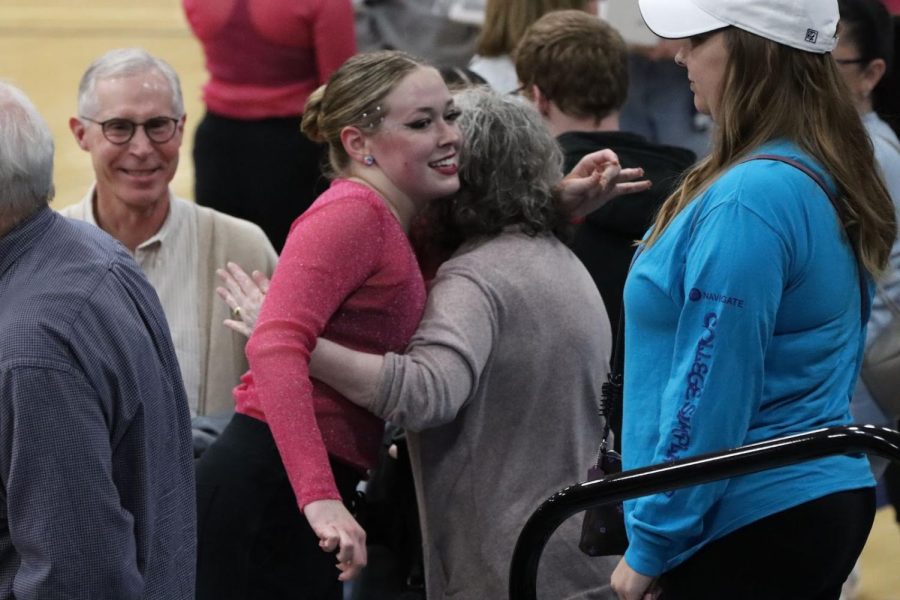 Mackenzie Meharry, freshman in forensic investigations, hugs her family after the hip hop performance. The Dancing Blues placed top 5 in the Nationals overall. 