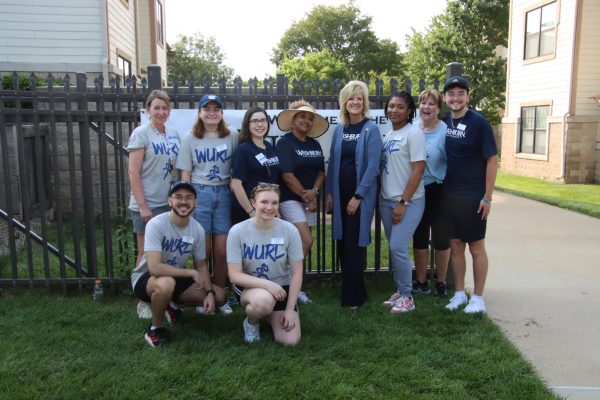 President JuliAnn Mazachek, poses with volunteers to welcome new residents of the Washburn Village. She was excited to see incoming students move into the dorms.
