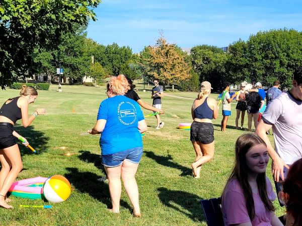 Greek life provides students with the things they need for the water activity in the hot sun. Students used a water blasters to splash other students. 
