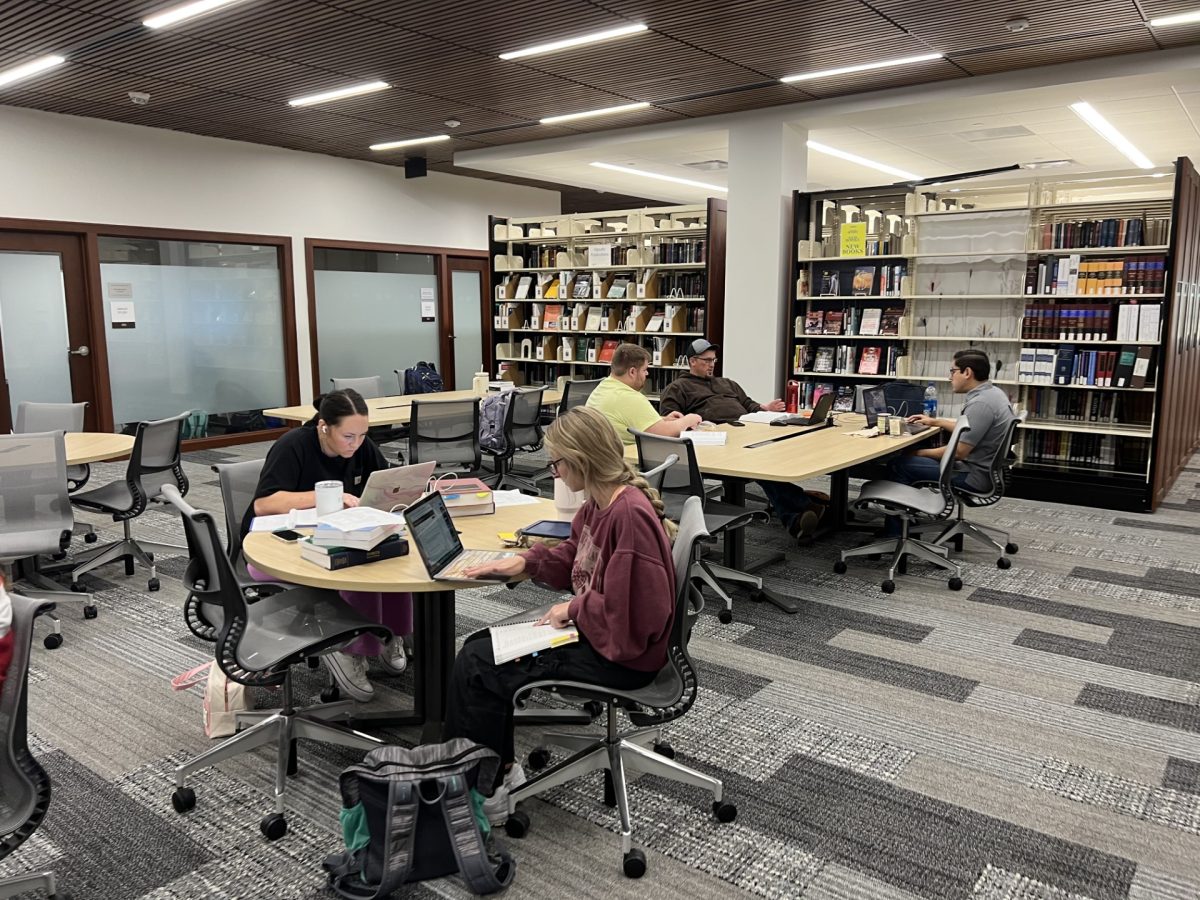 Students study in the new School of Law library. The library is located on the top floor and includes a reading room and study rooms.
