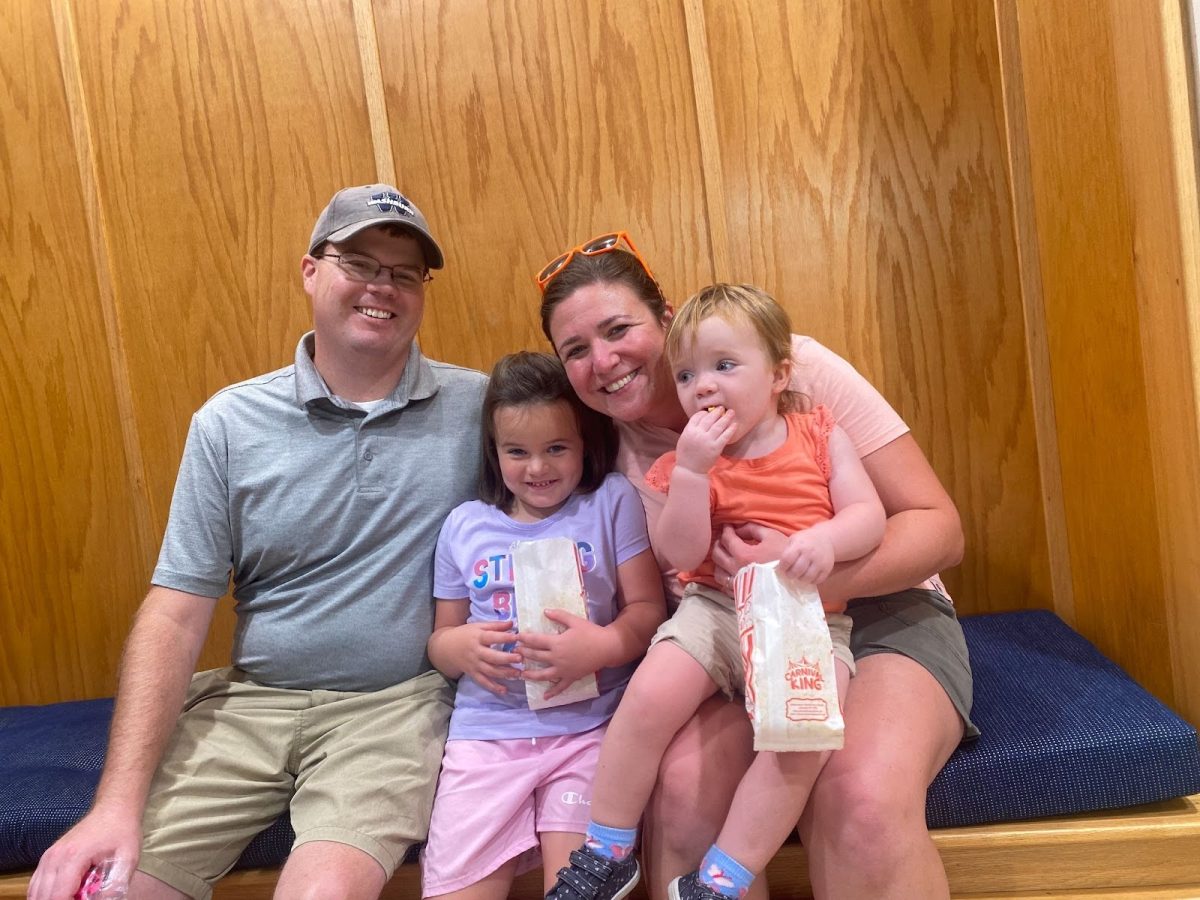 The Pfannenstiel family smiles for a photo. Heather Pfannenstiel (right) brought her husband and two daughters.