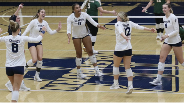 Ichabods celebrate with excitement after receiving a point. The point was scored on an ace serve by sophomore Corinna McMullen.