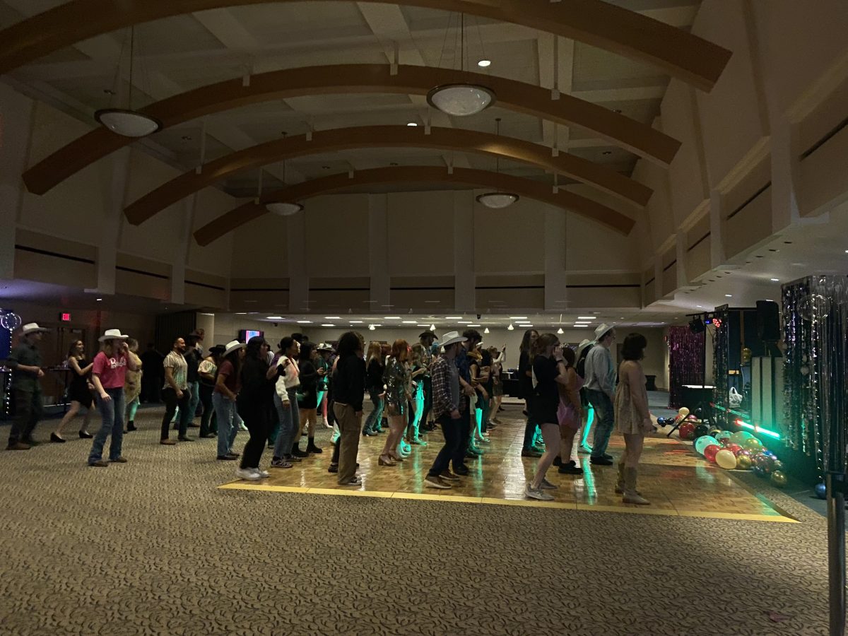 Washburn students gather up on the floor doing the cha-cha slide. The Homecoming dance was hosted by the Campus Activities Board Oct. 25, 2023. 
