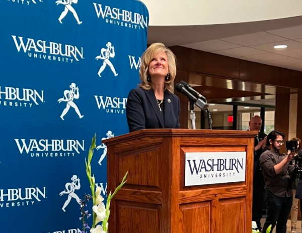 Mazachek smiles as the audience applauds and cheers. During the event, Mazachek announced that Washburn created a partnership with Shawnee County that will give high school graduates from the county a more affordable education through a scholarship.
