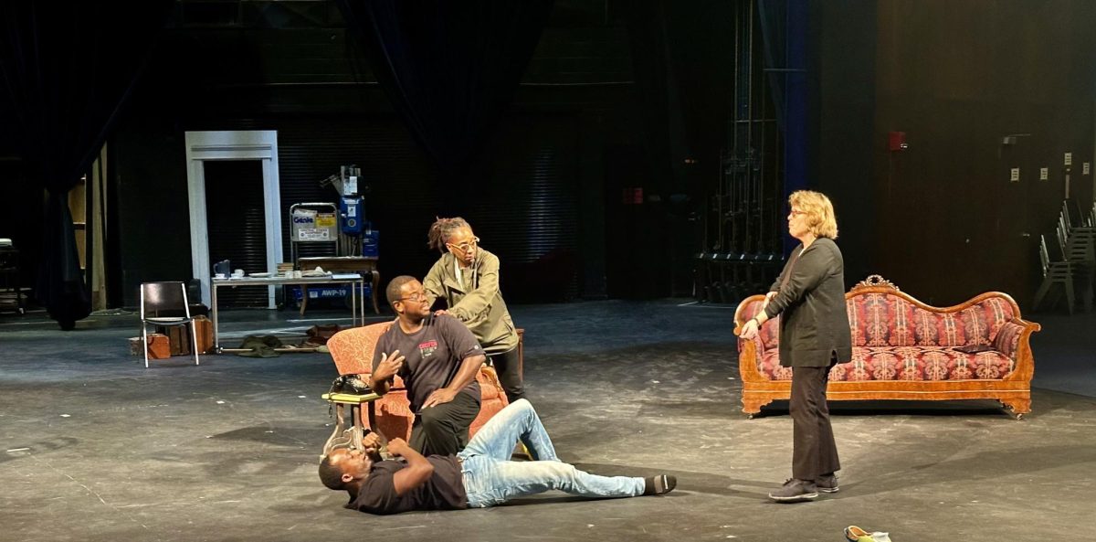 On the stage (left to right) Nyalia Lui, role Jack Colton; Jason Jones, role Roy Colton; Britt and Sullivan. In the middle of the scene, Sullivan gave directions to each of the actors on how to do an aggressive scene safely. 