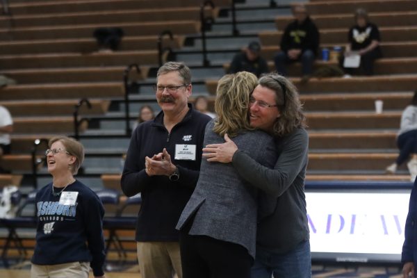 President JuliAnn Mazachek recognizes Park Lockwood, kinesiology professor, one of the Most Valuable Professors, during halftime of the game. The MVPs were professors nominated by members of the basketball team.