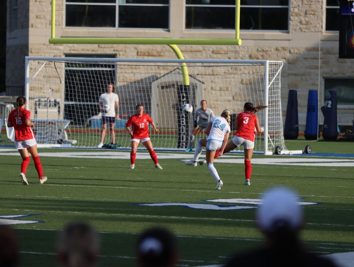 Mackinly Rohn, sophomore forward, kicks an attempted goal against UMSL. UMSL’s defense prevented the score.