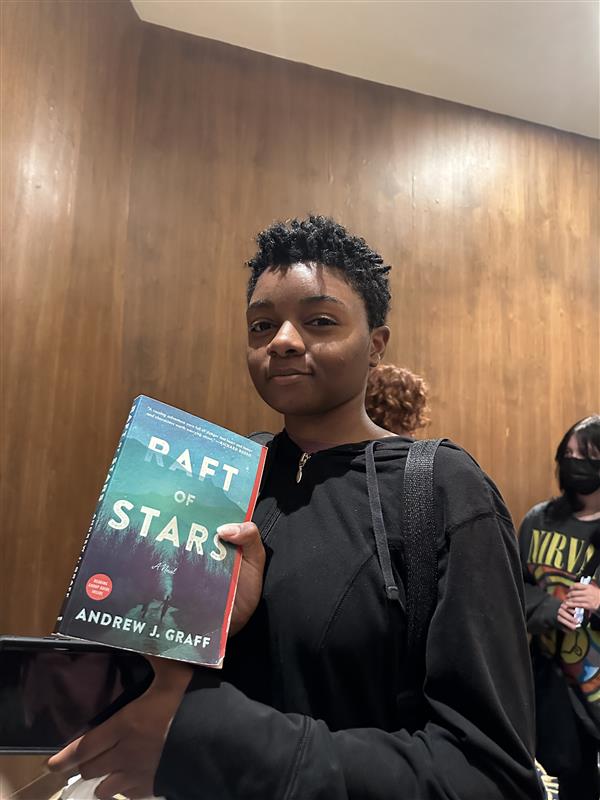 Raquel Easter, freshman accounting major, holds the book written by Graff. There were around 1,200 students at the event.