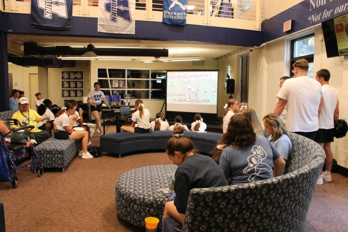 Students, cheer team and staff watch the first football game of Washburn University vs. Emporia State University. The Union Daze Tailgate took place Thursday, Aug. 29, in the lower level of the Memorial Union.