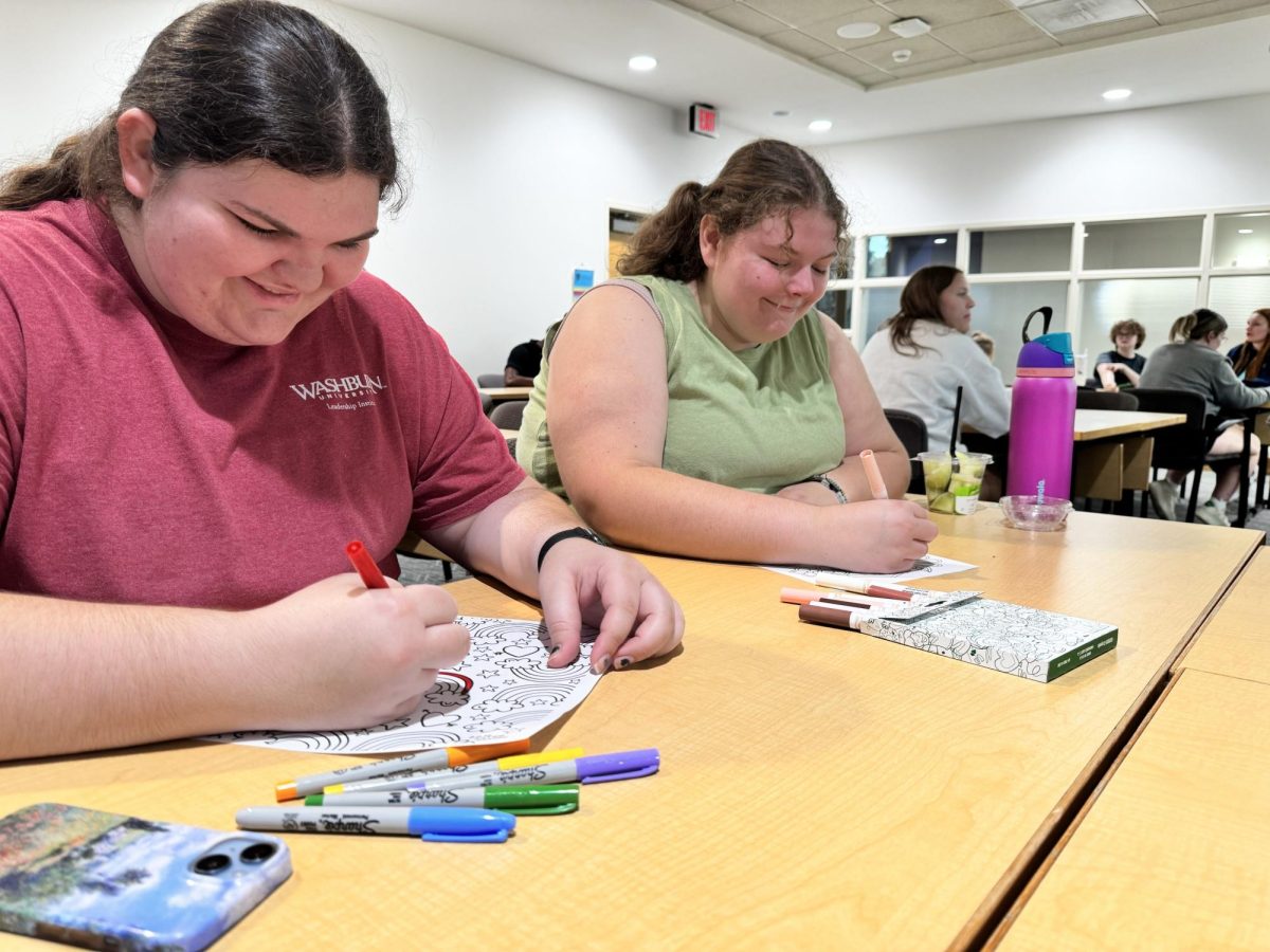 The meeting encourages members to color while they wait for it to start. Here are Jayden Coover and Taylor Redington, enjoying the coloring sheets. 