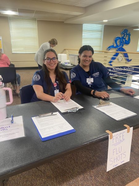 Alyx Salinas (left) and Morgan White (right) are both junior nursing majors who assisted students before getting the flu shots. Student Health Services organized the free flu clinic to allow students the opportunity to get vaccinated.