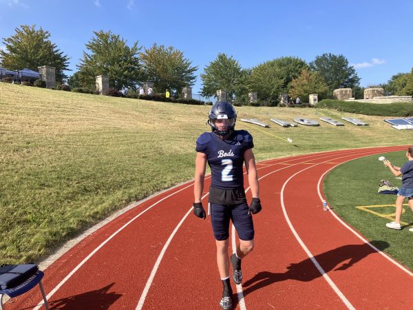 Caeden Spencer, senior Health and Fitness major, walks through Yager Stadium in full uniform. He, along with his fellow teammates, warmed up to go against the Colorado Mines.