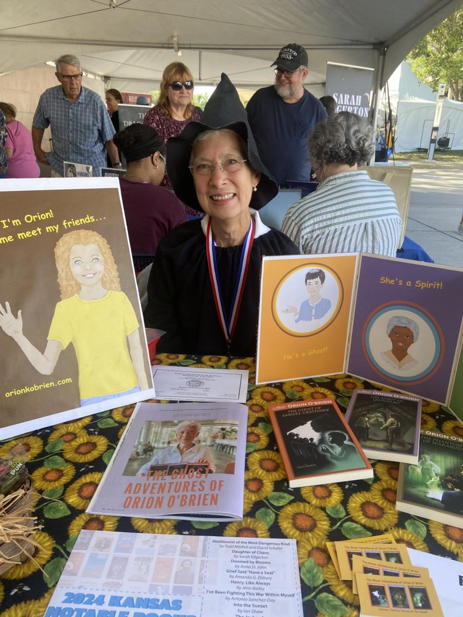 Fran Borin, ghost story writer, displays her recent book series, “The Ghost Adventures of Orien O’Brien.” She was one of 40 outdoor tent exhibitors at the festival.