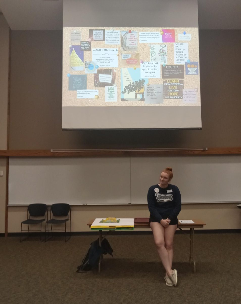 During the IgniteU session, Bella Wood, Washburn Student Government Association vice president, presents a collage board full of quotes. Students chose their favorite quote and shared with a partner why they connected with it.