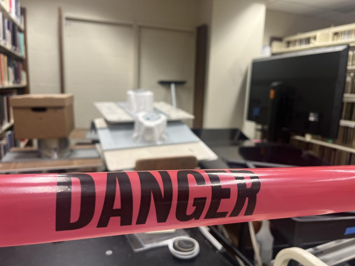 Danger tape blocking off a section of the fourth floor in the Plass Learning Resource Center. Phase one of Plass still has not been completed.