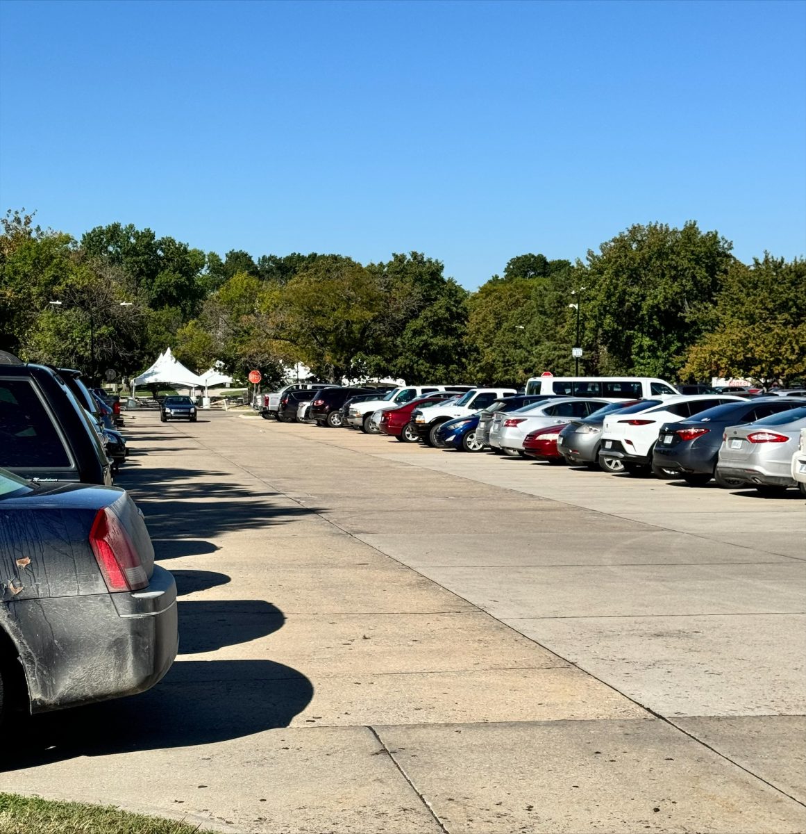  An example of a full parking lot with drivers circling to find a space. The scarce parking has made it difficult for students to get to class on time. 
