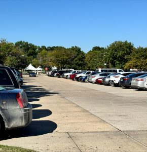  An example of a full parking lot with drivers circling to find a space. The scarce parking has made it difficult for students to get to class on time. 
