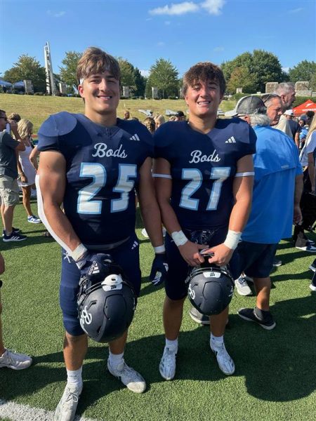 J.C. Heim (left) and Jaren Heim (right), freshmen linebackers, smile for a photo after a game. The twin brothers have played football together since kindergarten.
