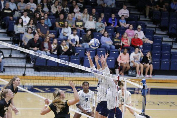 Jalyn Stevenson, senior outside hitter, and Alex Dvorak, junior middle hitter, go up for a block. The duo put up 6 blocks in the match. 