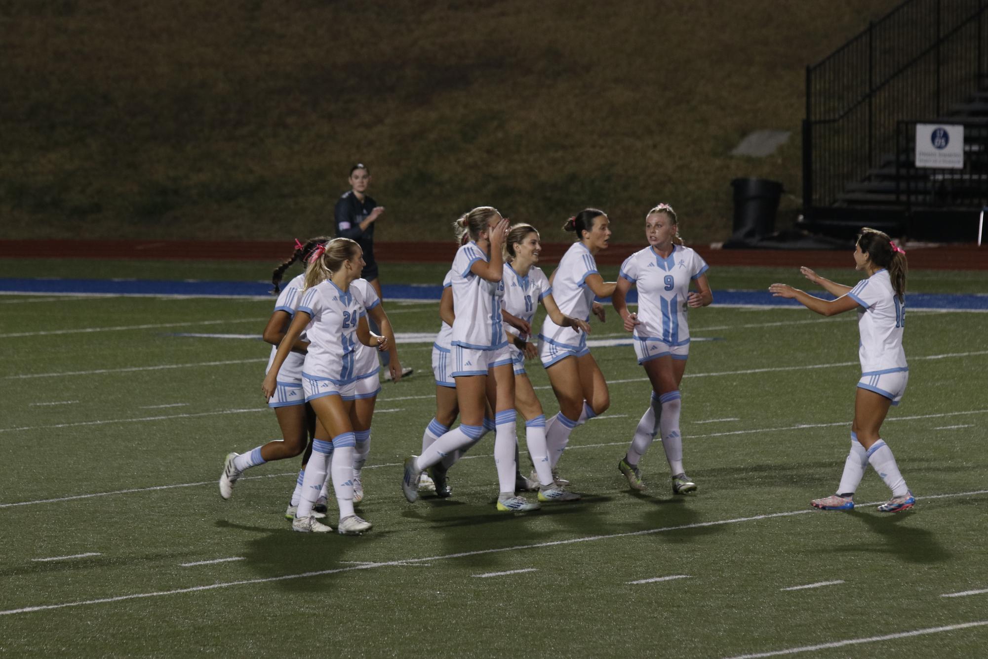 Washburn players celebrate a goal scored by Khloe Schuckman, senior forward. The goal led to a very lively atmosphere and the crowd went crazy.
