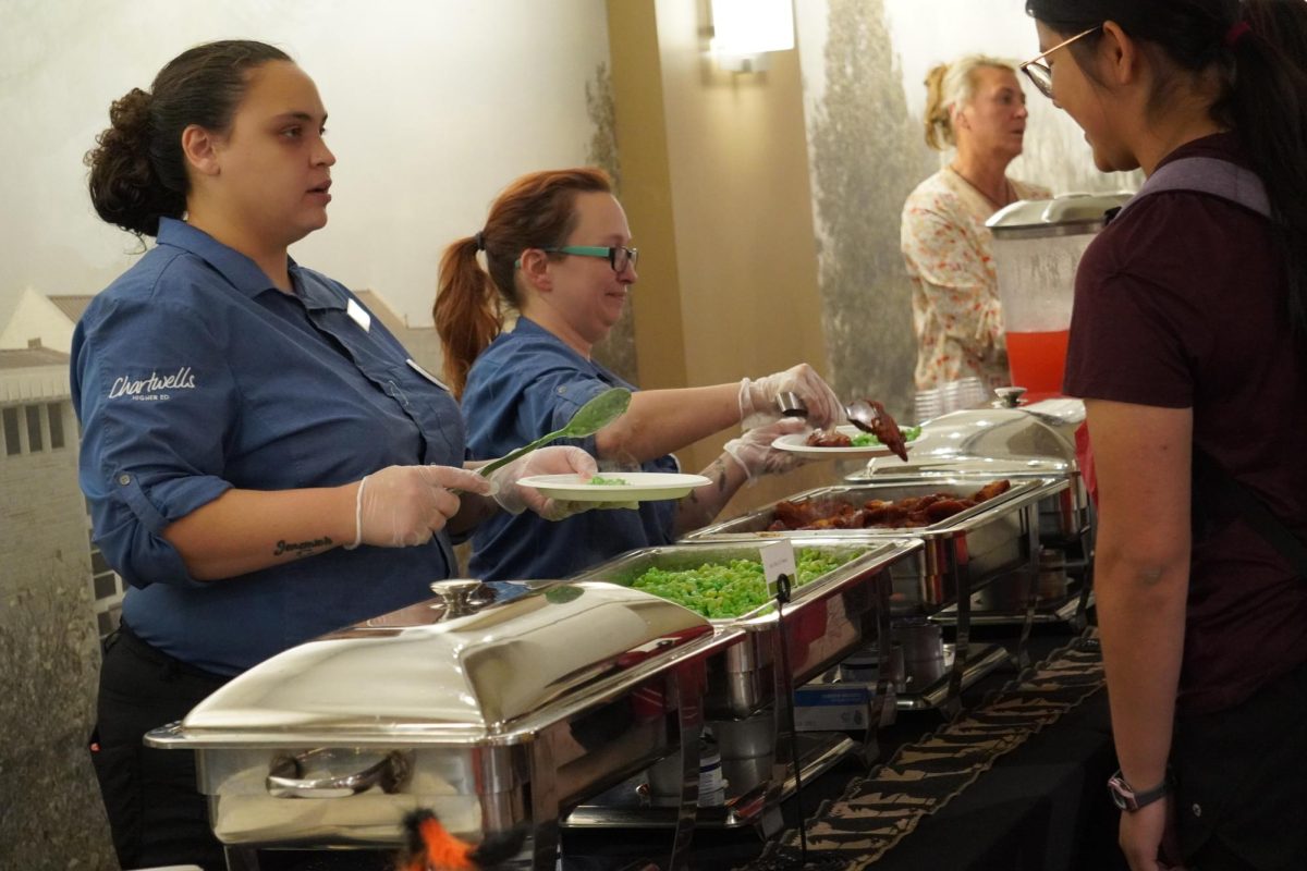 Students fill their plates with delicious food before taking a seat. There were “bloody tenders” and “toxic mac and cheese” courses being served. 