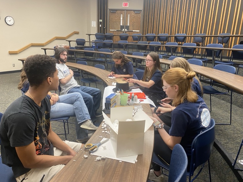 The Psychology Club creates its top hat after the discussion. The members discussed the upcoming clothing drive.