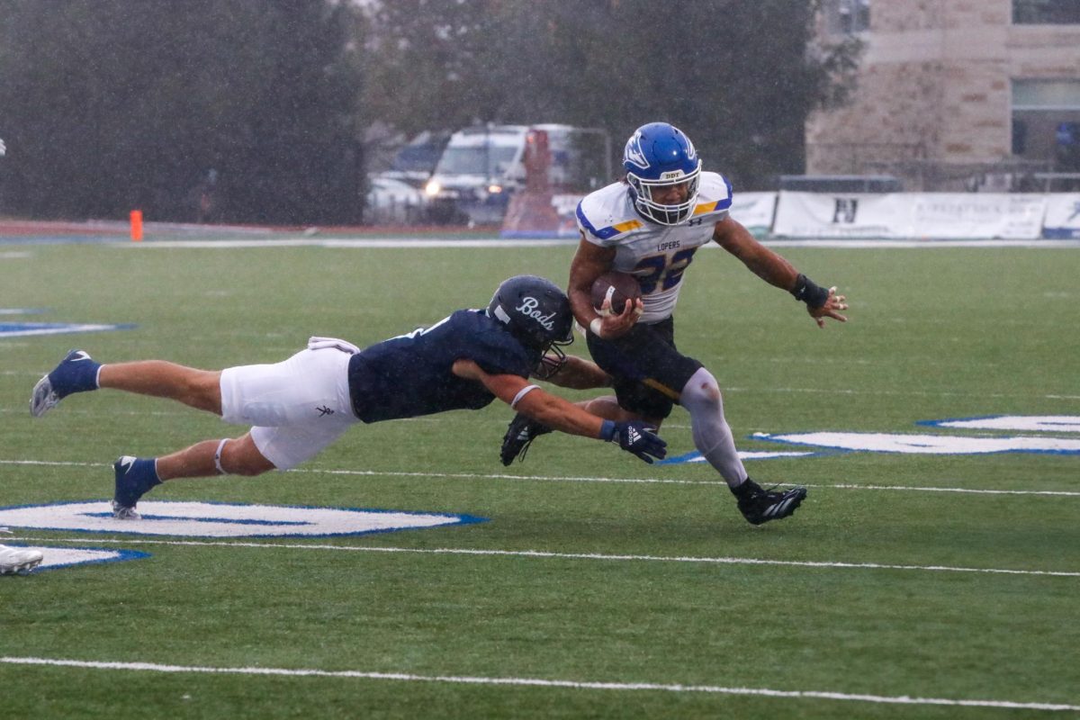 Jordan Finnesy, junior safety, dives to tackle a UNK running back. Throughout the game, Finnesy racked up 12 stops for the Washburn defense. 