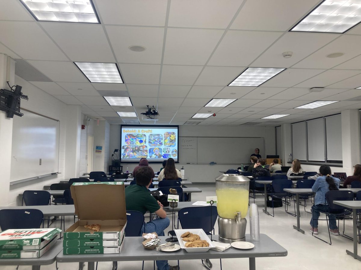 Faculty advisor Benjamin Reed gives a presentation on how to write a curriculum vitae after finding out what troubled the student most. The meeting helped students prepare for graduate school.