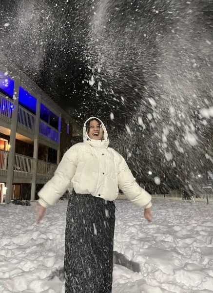 Jenisha Thapa throwing snow on campus. This was during the first big snowfall in Topeka.