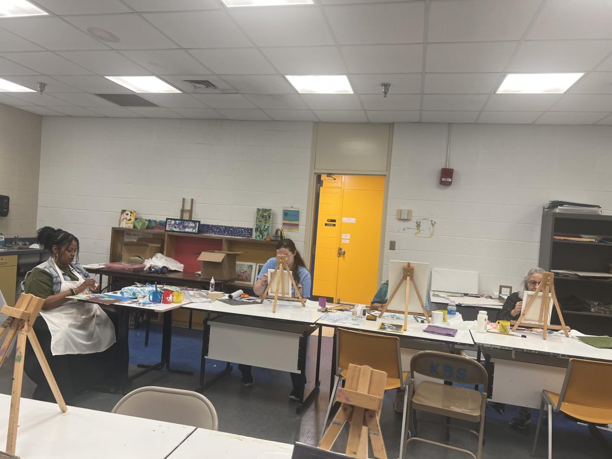 Participants stroke their brushes on their portraits along with Aisah Imani Sanaa, the visiting artist. 
They portrayed their own visionary art.

