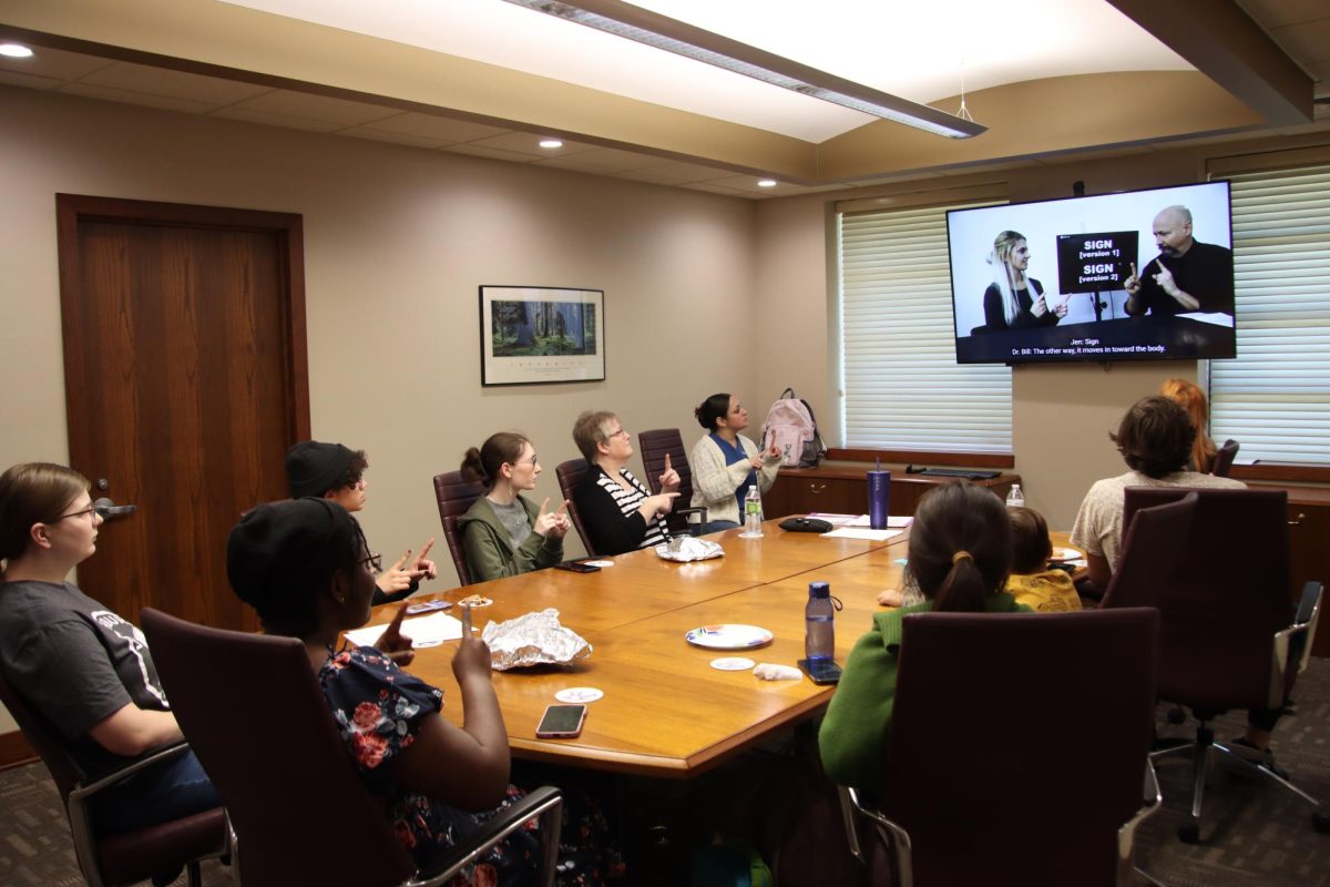 Students learn basic American Sign Language with the help of an instructional video during the ASL club’s meeting. The club held its first meeting and introduced the members to foundational signs.