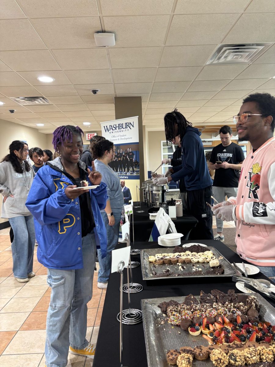 Latrice Hysten, sophomore entrepreneurship and innovative marketing major, selects a dessert during the event. The event saw a large number of students stopping by throughout the event.
