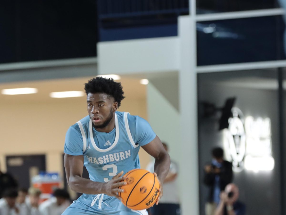 Senior guard Bryson Smith dribbles the ball to pass it to his teammate. Smith made a significant impact with 22 points, with one 3-pointer, 4 rebounds and 5 assists.
