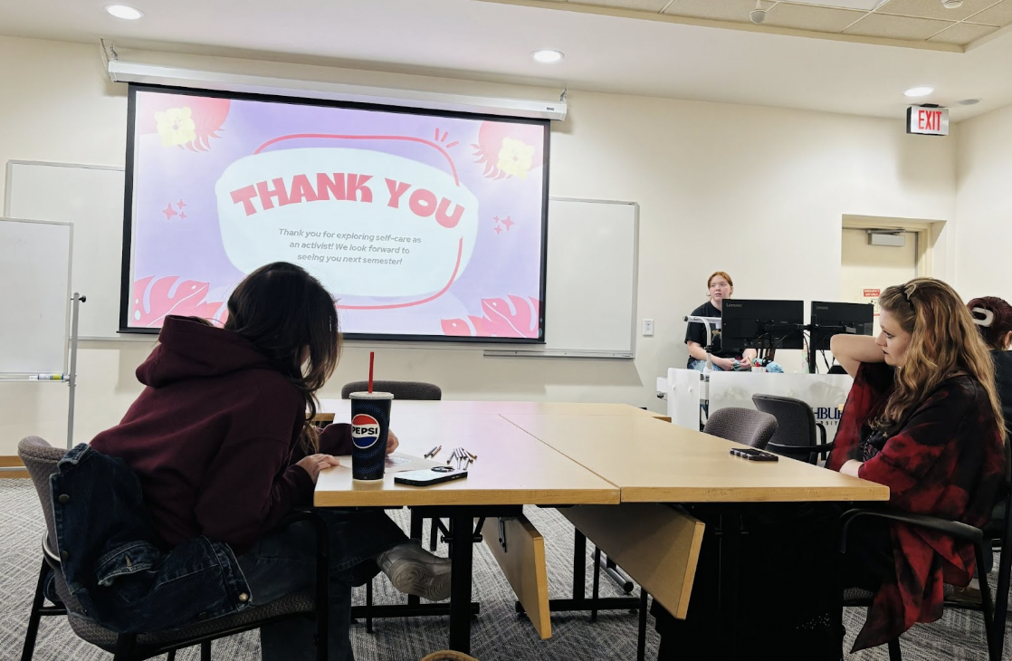 Maggie Bourell, president of URGE Washburn, leads the self-care workshop in the Blair Room. The event included stretching, coloring activities and care packages set out for attendees.
