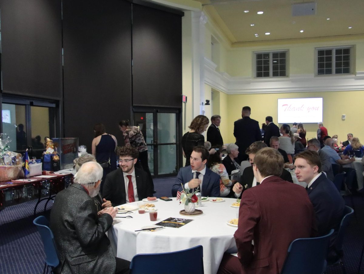 Kappa Sigma members chat with guests during the veterans’ event, where they had shared conversations and connections over dinner earlier in the evening.
