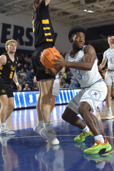 Senior guard Bryson Smith looks for an open teammate to pass the ball. Smith scored a Washburn high with 6 assists.
