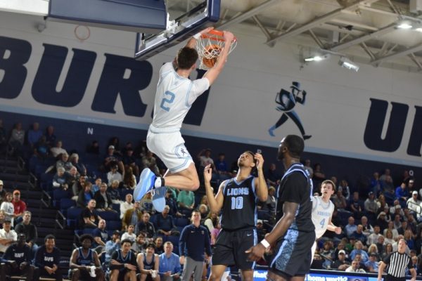 Ruud dunks on the Fort Smith Lions. Rudd ended the game with 9 rebounds.