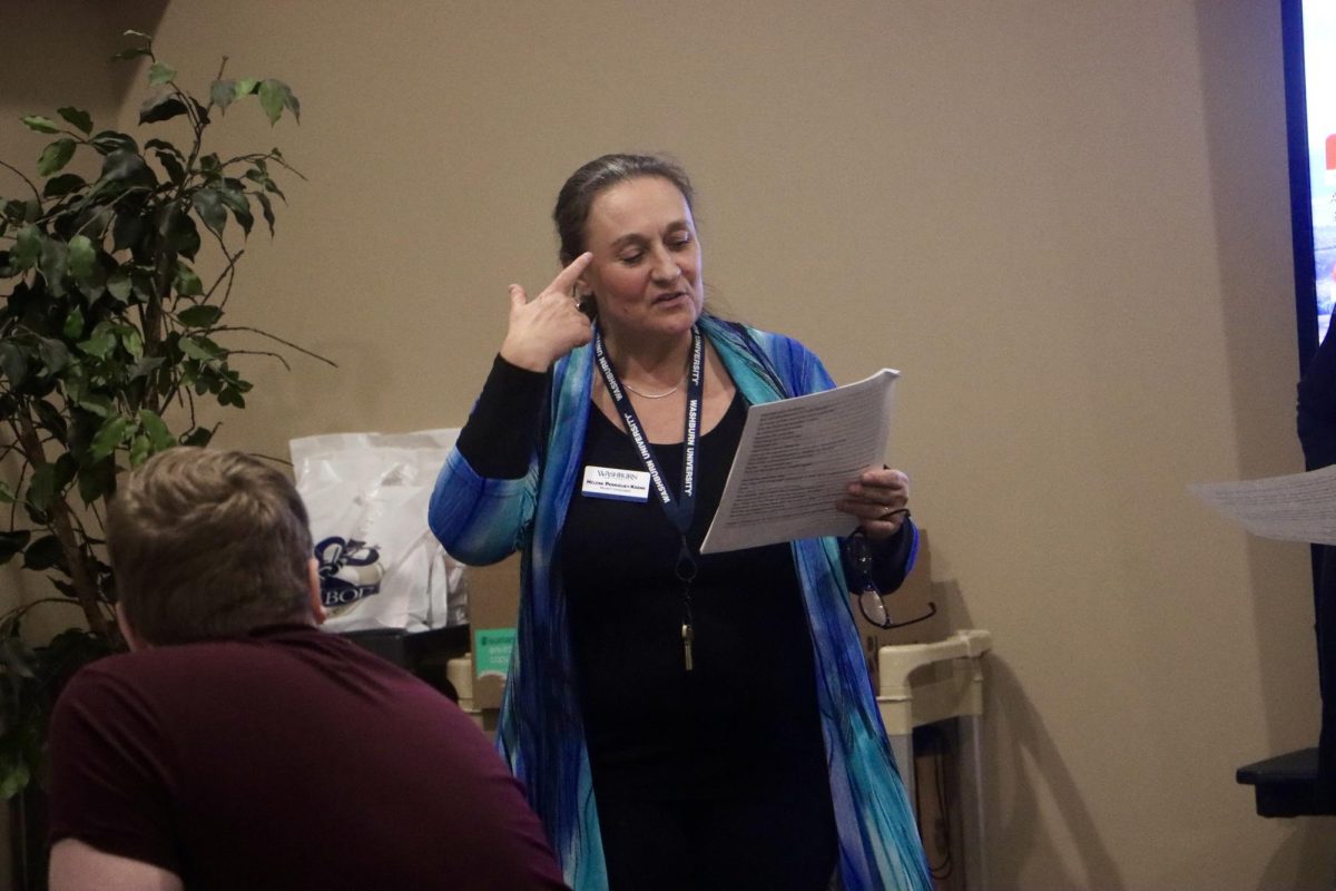 Helene Perriguey-Keene, lecturer in French and Spanish and one of the organizers of this event, reads a script of the drama that students were going to perform. The event was held from 9 a.m. to 2:30 p.m.
