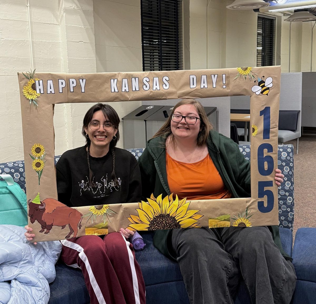 Viryriana Flores, senior art history major and Shaylee Giles, junior forensic biology major, pose for a photo during a Kansas Day event on campus. The event was held to celebrate Kansas statehood.
