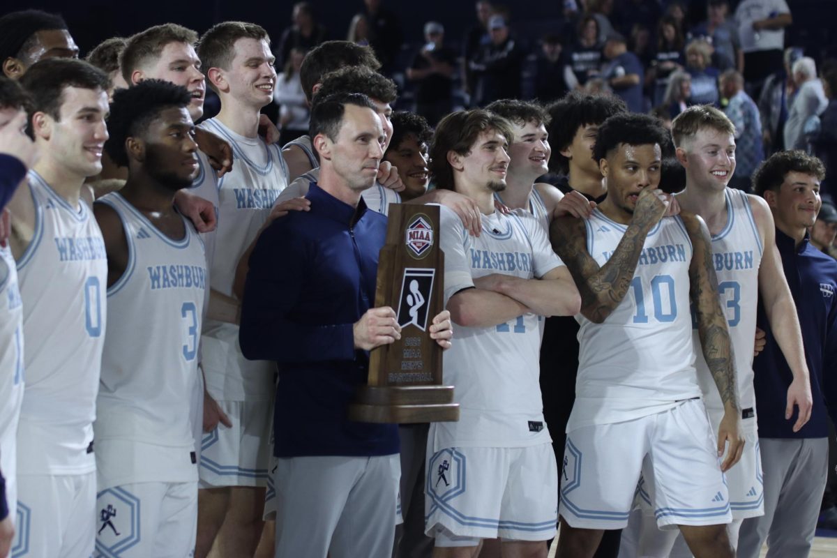 Ichabods receive the MIAA Championship trophy from Washburn President JuliAnn Mazachek. Washburn men’s basketball secured the 88-49 win and celebrated their 28th straight home victory.