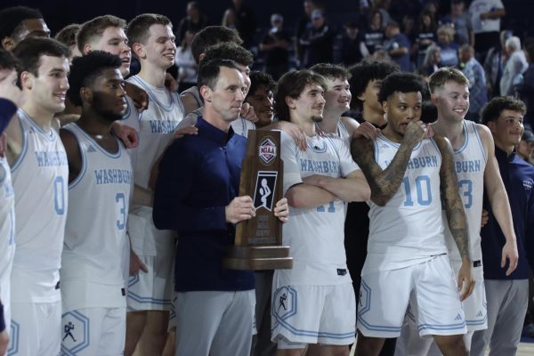 Ichabods receive the MIAA Championship trophy from Washburn President JuliAnn Mazachek. Washburn men’s basketball secured the 88-49 win and celebrated their 28th straight home victory.