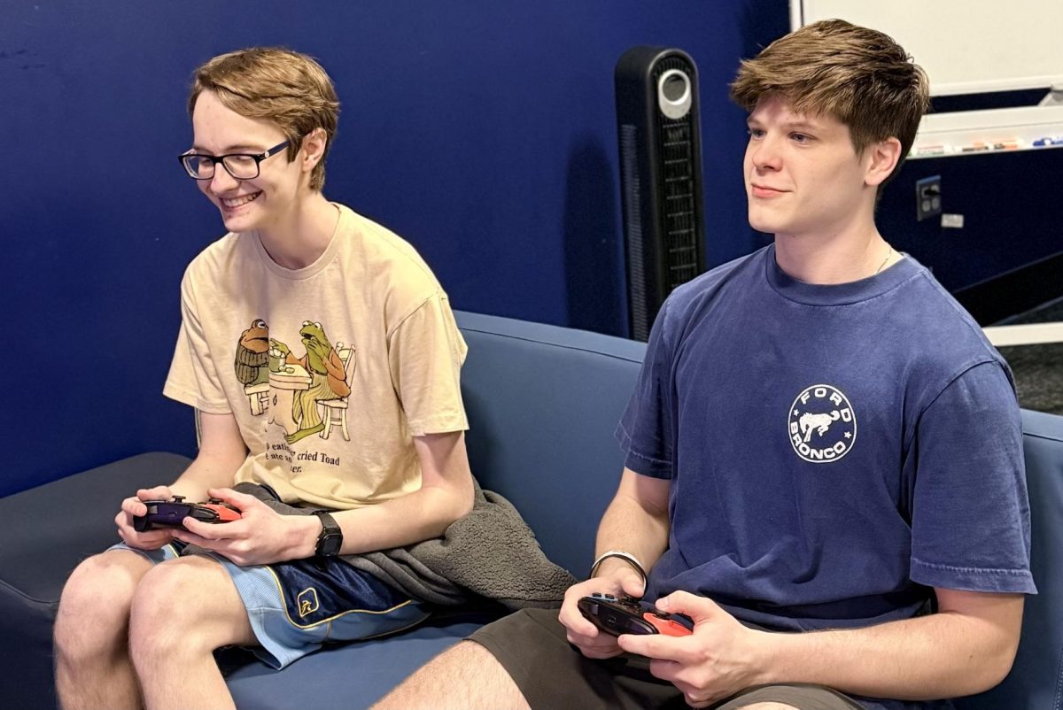 Chase Ryckman (right), sophomore marketing major and Brandon Parnell (left), sophomore mathematics major, compete against each other during a Mario mini tournament at the Washburn esports lounge. Washburn students, along with regular esports players participated in the event.