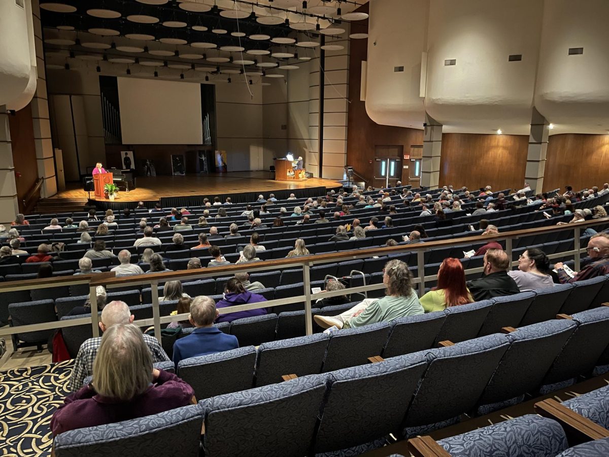 The audience prepares for the first film in the Kansas Silence Festival of the evening, “Cinderella.” Speaker Denise Morrison stood on the stage and discussed the history of this film.
