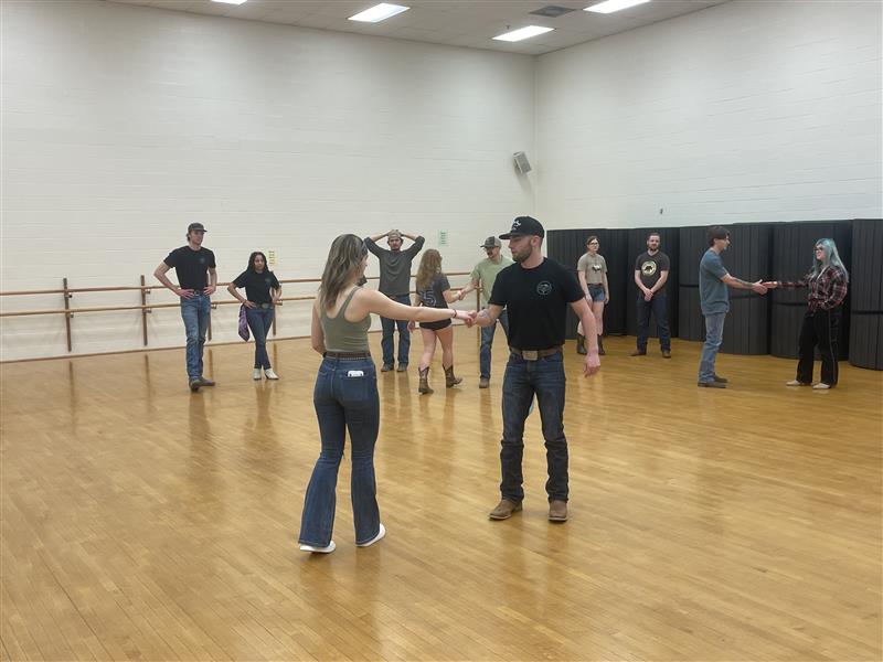 Jadyn Falley, president of swing dance club, and her dance partner, Jordan Ball, prepare for the “wrecking ball” move. All the dancers gathered around to learn.
