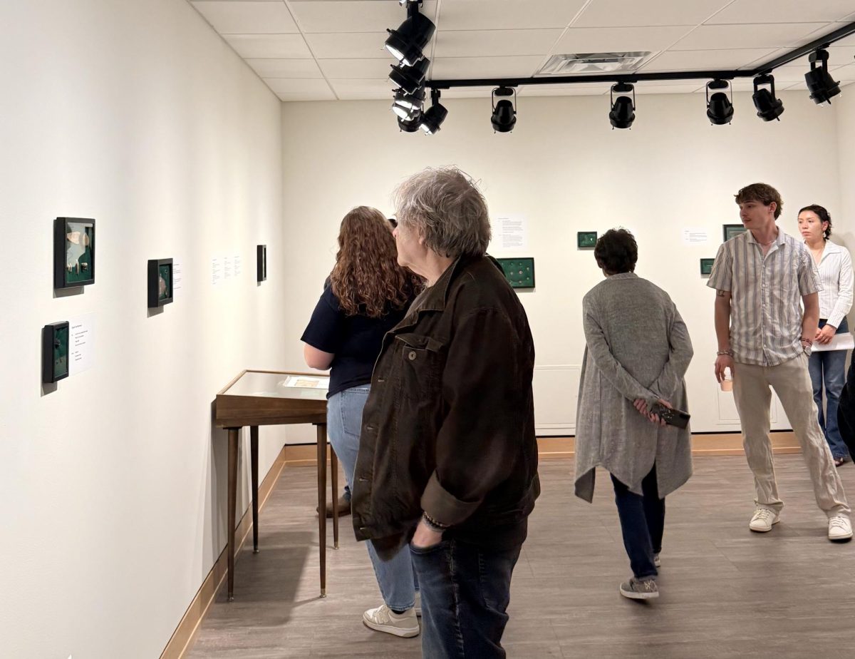 Participants and family members participate in the Washburn student exhibition to support the students. The event was open to the public, and visitors were served food and drinks.

