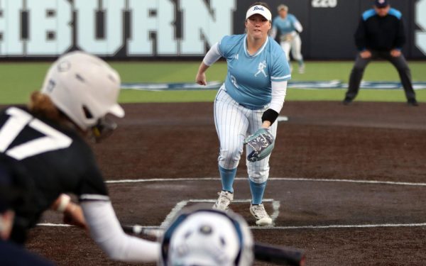 Senior pitcher Jenna Sprague prepares to intercept a bunt from the batter. Sprague allowed five runs over the course of the game.
