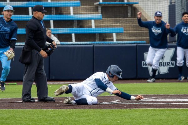Junior outfielder Levi Risenhoover slides into home base to score the final run of the game against the Lions. Risenhoover went 1-for-4 with 2 RBI and scored 2 runs.