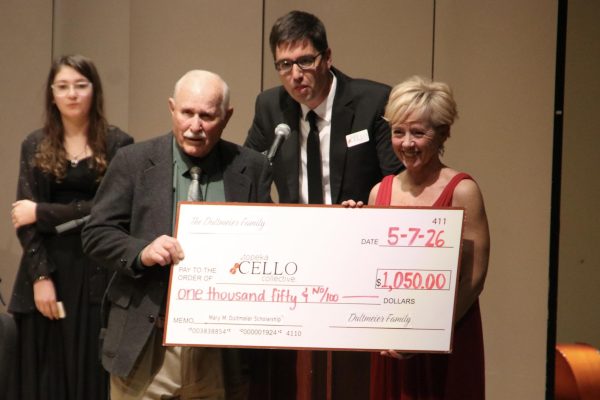 Topeka Cello Collective founder and director Erinn Renyer (right) and Stones (middle) recognized a family member of sponsor Mary Dultmeier for a $1,050 donation to the organization’s general fund. Dultmeier was remembered as a dedicated supporter of the Topeka arts community.