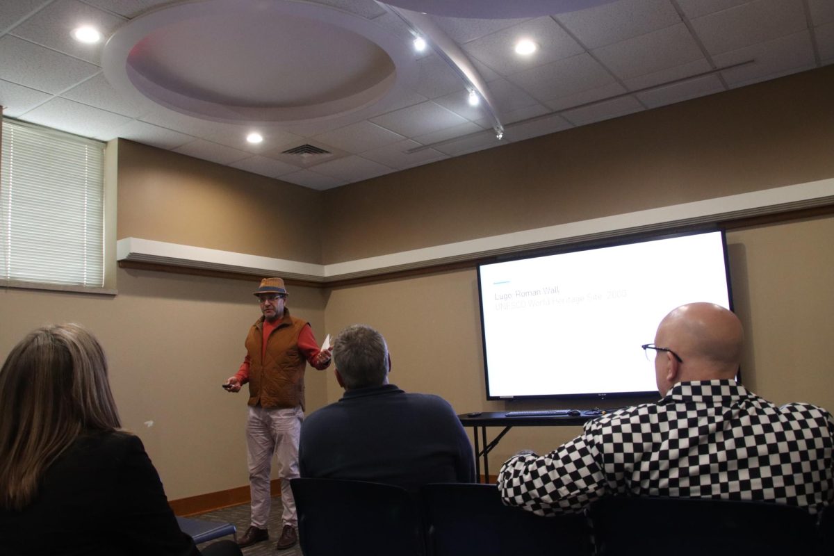 Miguel Gonzalez-Abellas, professor and chair of modern languages, gives a presentation about his visit to Northern Spain during summer 2025. He highlighted the visit to Sagrada Família in Barcelona, designed by Antoni Gaudí, as one of the most memorable parts of the trip, noting that it is the most visited monument in Spain.  